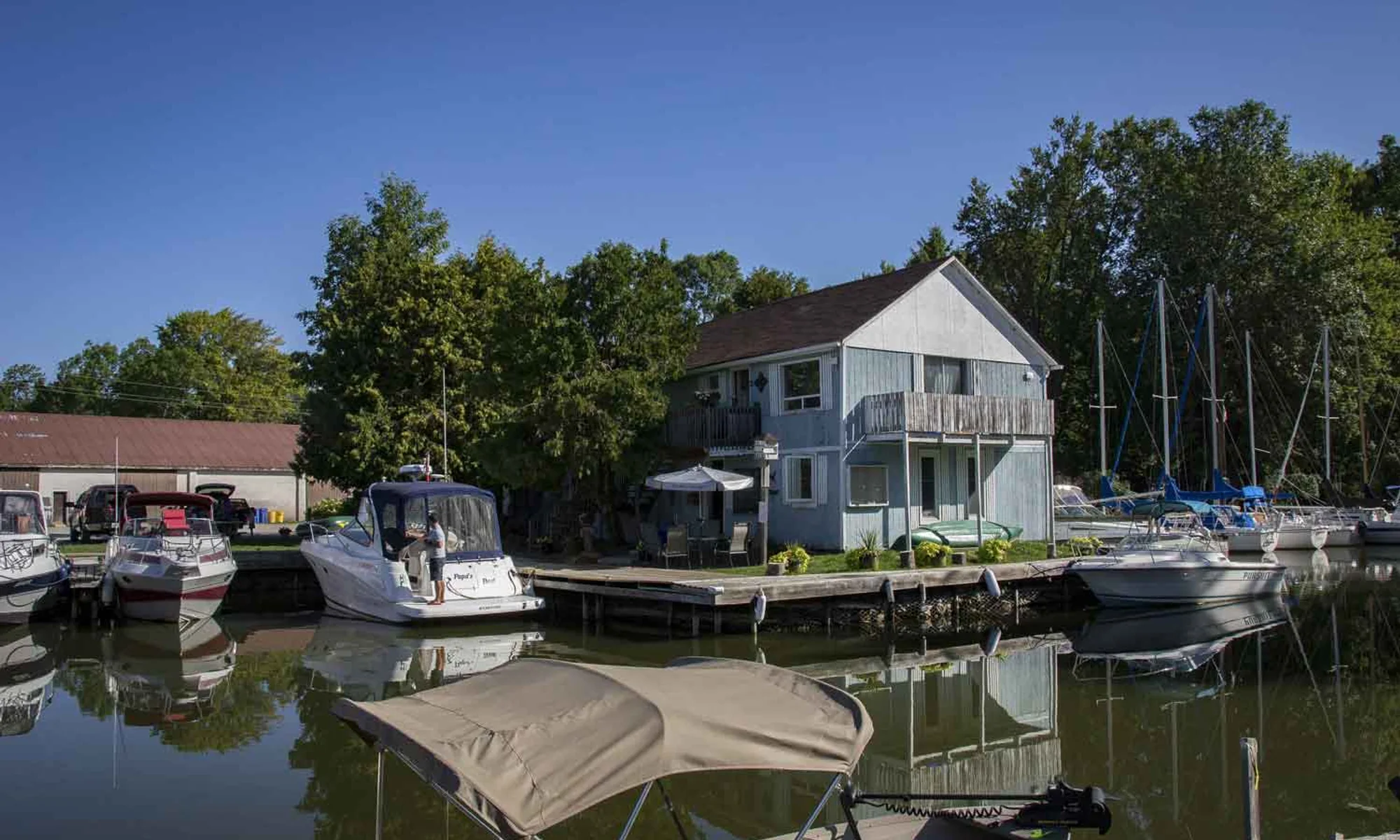 Boats docked at Cooks Bay Marina on Lake Simcoe at golden hour